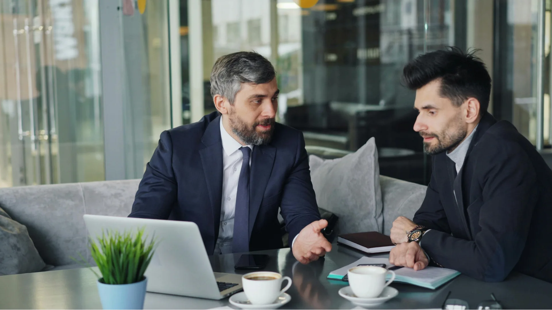 Business consultants reviewing growth strategy and digital systems on a laptop